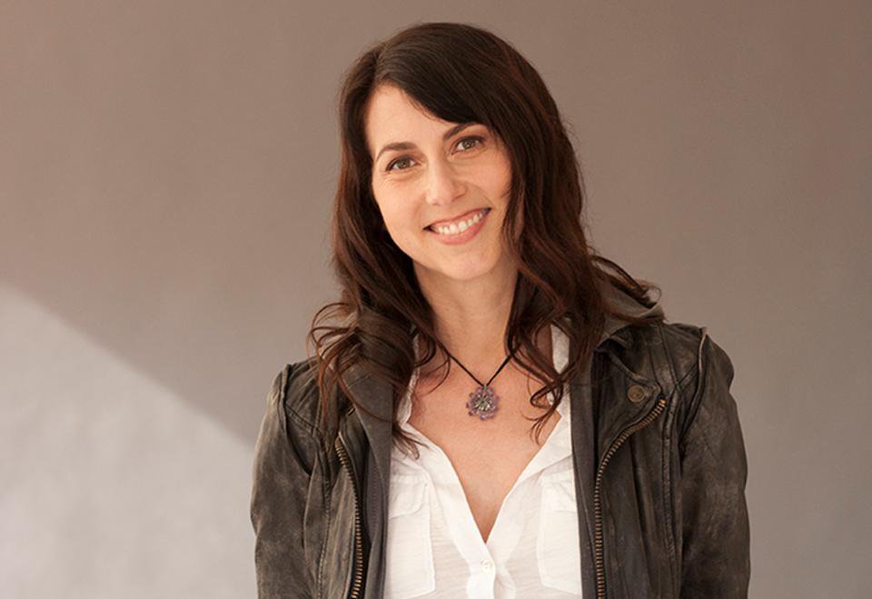 histories_arch's tweet photo. MacKenzie Tuttle (now known as MacKenzie Scott) went from helping start Amazon in a garage to becoming one of history's most generous and quiet philanthropists. 

MacKenzie Tuttle was sitting at a desk at D.E. Shaw in New York when she first met Jeff Bezos. She was twenty-two years old, had just graduated from Princeton, and needed to pay off her debts.

"I was looking for a job to pay the bills while writing my novel," she later recalled about that period in her life.

She was an English literature major, but she was good with numbers, so the hedge fund hired her. When Jeff came up with the wild idea to sell books on the internet, MacKenzie did not hesitate to join him.

In 1994, they packed up their car and drove across the country to a small rented house in the Seattle area. They set up spray-painted wooden doors as makeshift desks in a damp garage.

"We worked until our arms standardly ached packing those boxes," she said in an interview years later.

She served as Amazon's first accountant, wrote its original business plans, handled customer support, and packed shipping boxes on her knees on the cold concrete floor.

In its first year, the scrappy startup made $511,000.

As Amazon grew into an e-commerce giant, MacKenzie stepped back to raise their four children and pursue her passion for writing. She wrote two acclaimed novels, winning an American Book Award in 2006.

For decades, the public saw her simply as the quiet wife standing beside a billionaire tech mogul, but she knew the exact sweat and sleepless nights that had built the company. Her journey was never as smooth as it looked from the outside.

During her high school years at Hotchkiss, her family went bankrupt.

At Princeton, she was so broke that a roommate loaned her $1,000 to keep her enrolled, and a kind dentist treated her for free after noticing she used denture glue to hold a broken tooth together.

She never forgot how it felt to have nothing, and she never forgot the strangers who helped her survive those lean years.

When the couple divorced in 2019, MacKenzie Scott walked away with a four percent stake in Amazon, worth roughly $36 billion.

Rather than holding onto the fortune, she signed the Giving Pledge just months later.

"I have a disproportionate amount of money to share," she wrote in a simple open letter.

She launched Yield Giving, a philanthropic organization that gave massive cash grants to charities with no strings attached.

The initial phone calls to non-profit directors were almost surreal.

"Is this a joke?" one food bank director asked after hearing that a team was transferring tens of millions of dollars to their bank account overnight.

"We couldn't believe anyone would trust us this much without mountains of paperwork," another charity leader said through tears.

She focused on grassroots causes: tribal colleges, women's health clinics, prison reform programs, and neighborhood food pantries.

By 2025, she had given away more than $26 billion to over 2,700 organizations, completely transforming the world of charitable giving.

She started in a garage with no money, built something massive, and then gave it back to the people who needed it most.

Her name might not be on the front of any corporate headquarters, but her impact is etched into millions of human lives.

#archaeohistories