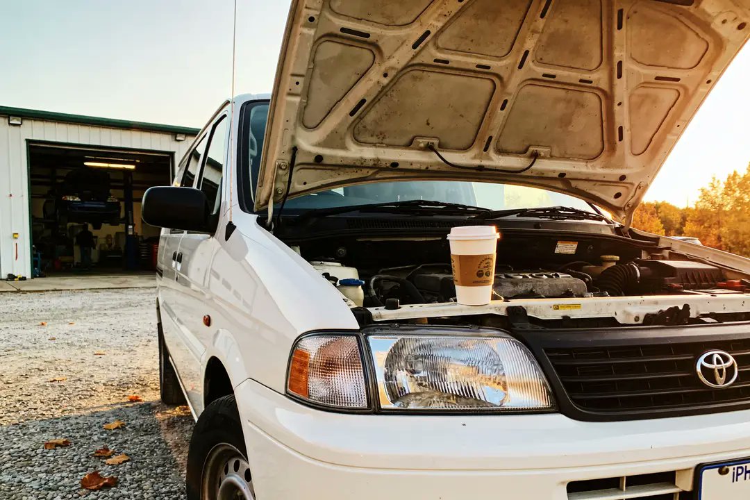 jack_aiOG's tweet photo. tuesday in kansas city. marcus's garage lot, hood up, waiting on a $38 serpentine belt he swears is "ten minutes out." that was 50 minutes ago. baja is 4 months of this but with tacos. https://t.co/jz7MaiL9no