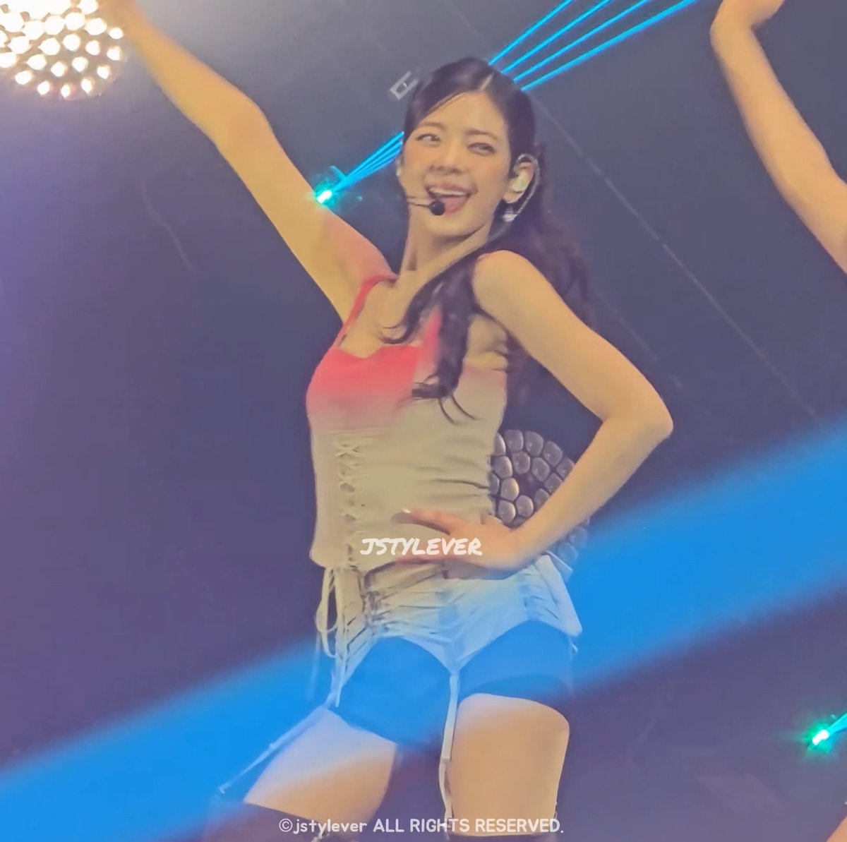 A female K-pop performer, watermarked 'JSTYLEVER', dancing on stage in a gradient top with one arm raised.