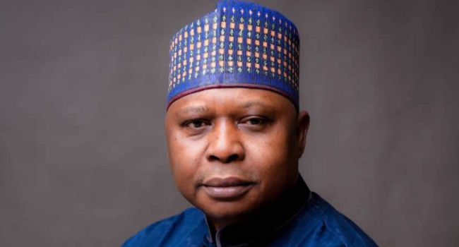 The image shows a man wearing a blue patterned traditional cap and matching blue outfit against a gray background. Based on the accompanying post, this appears to be Kabiru Turaki, National Chairman of the Peoples Democratic Party (PDP), who is pictured in a formal portrait accompanying his public warning to Nigerians about trading their votes for money or items like spaghetti in the 2027 elections.