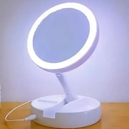 A white LED ring light mirror on a stand with a USB cable, positioned on a wooden surface.