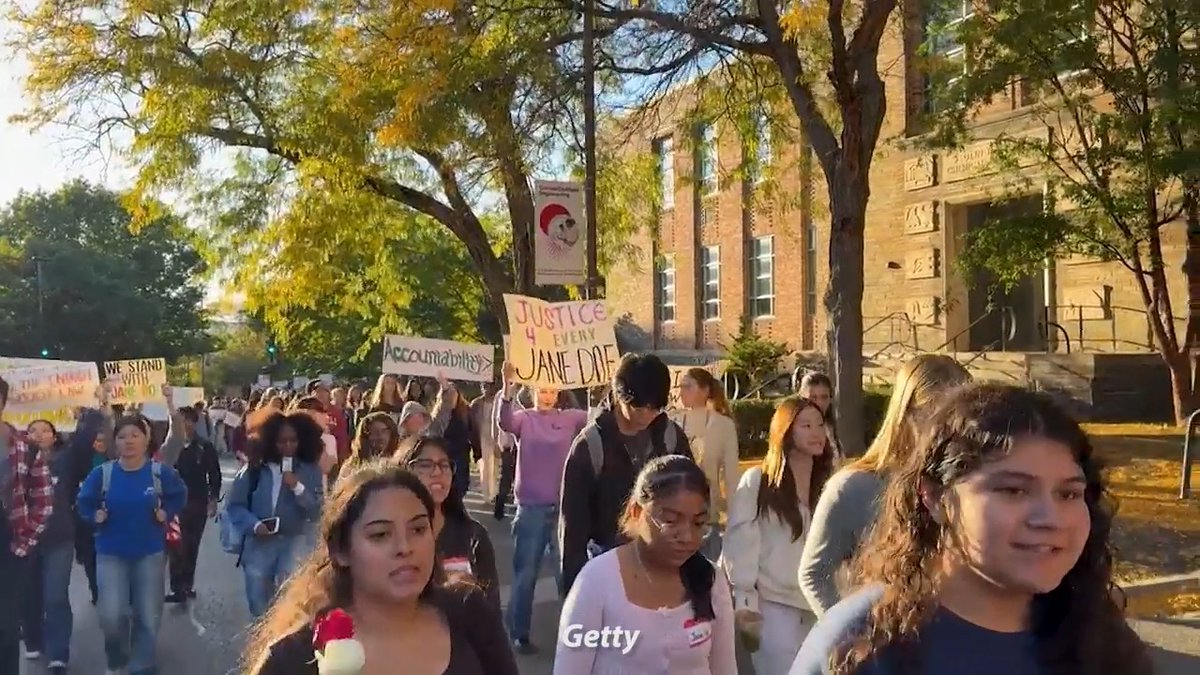 A crowd of Cornell students marches down a campus sidewalk holding signs that read "Justice 4 Every Jane Doe," "Accountability," and "We Stand With Jane Doe" in solidarity with an alleged gang rape victim, matching the accompanying post about campus protests supporting "Jane Doe."
