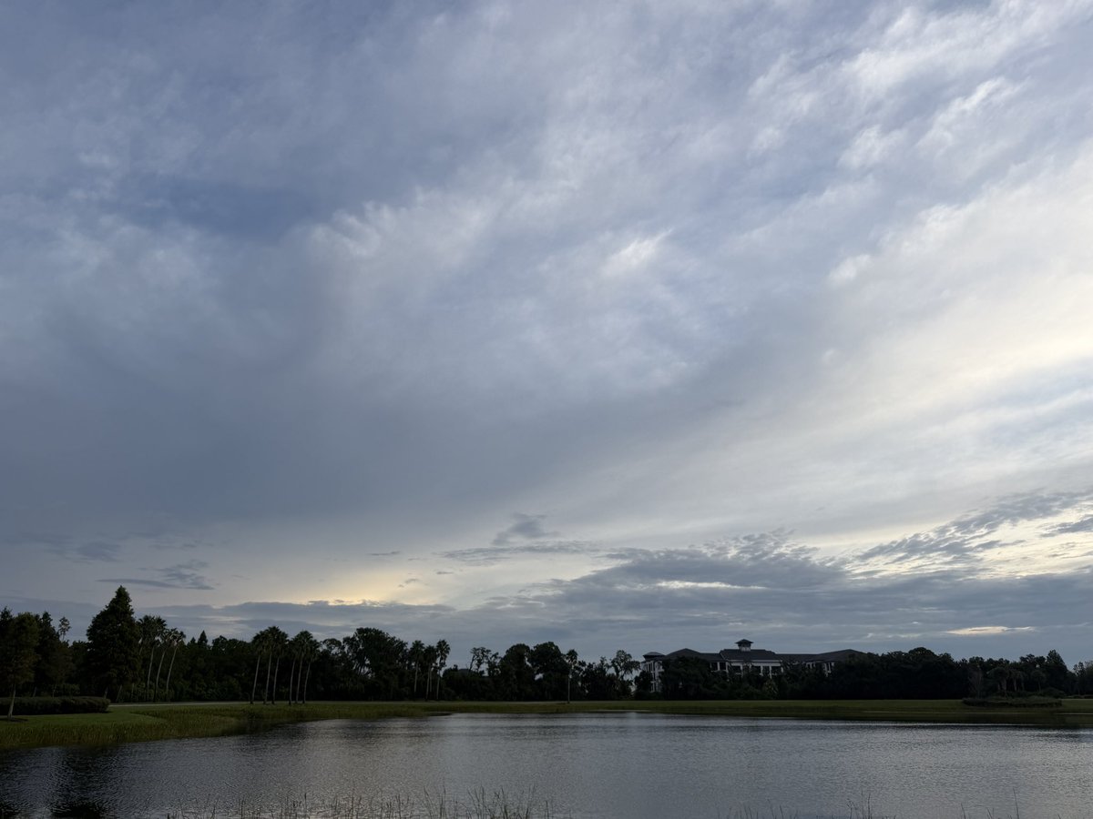 Figlinski's tweet photo. This was the sky this morning as I rounded the lake—the halfway point of my 3.5-mile walk. I started a new audiobook along the way, Mean High Tide by James W. Hall, the third book in his Thorn series. If you enjoy Florida fiction like I do, Hall is well worth reading. I’ve made my way through all of Randy Wayne White’s books and the older John D. MacDonald novels, and Hall has that same kind of Florida atmosphere I’m drawn to.
We’re supposed to get rain off and on most of the week, which usually means more clouds, changing light, and some interesting morning skies. I’ll be watching. Have a good day, everyone!