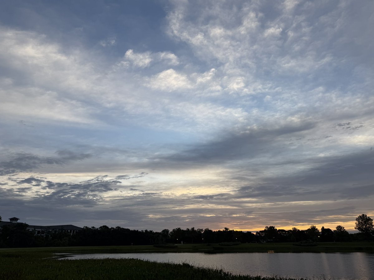 Figlinski's tweet photo. This was the sky this morning as I rounded the lake—the halfway point of my 3.5-mile walk. I started a new audiobook along the way, Mean High Tide by James W. Hall, the third book in his Thorn series. If you enjoy Florida fiction like I do, Hall is well worth reading. I’ve made my way through all of Randy Wayne White’s books and the older John D. MacDonald novels, and Hall has that same kind of Florida atmosphere I’m drawn to.
We’re supposed to get rain off and on most of the week, which usually means more clouds, changing light, and some interesting morning skies. I’ll be watching. Have a good day, everyone!