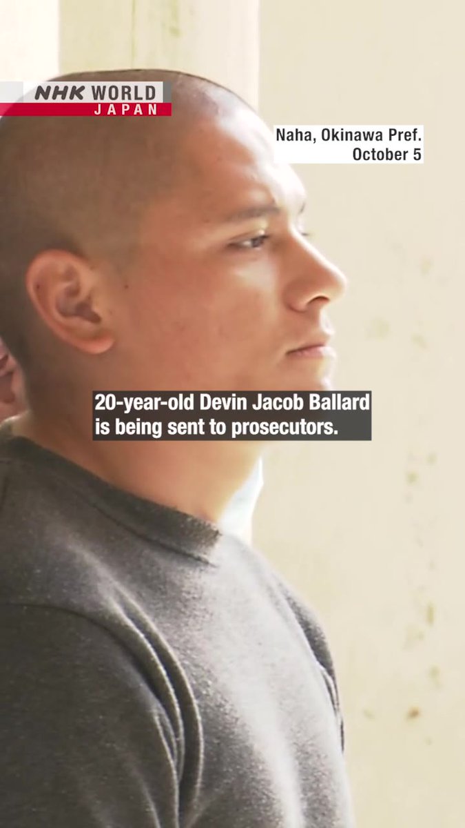 An NHK World Japan news screenshot dated October 5 from Naha, Okinawa Prefecture. The caption reads '20-year-old Devin Jacob Ballard is being sent to prosecutors,' shown over a profile photo of a young man with a shaved head.