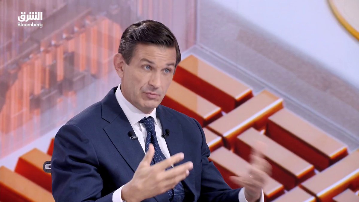 Ben Powell, Head of Investment Strategy at BlackRock Investment Institute for the Middle East, Asia, and Pacific region, is interviewed on Bloomberg's Al-Monitor program (with "الشرق" and "Bloomberg" logos visible), gesturing while discussing how Gulf investment booms are creating capital demand with increasingly stringent investor requirements, set against a backdrop of orange-toned financial graphics.