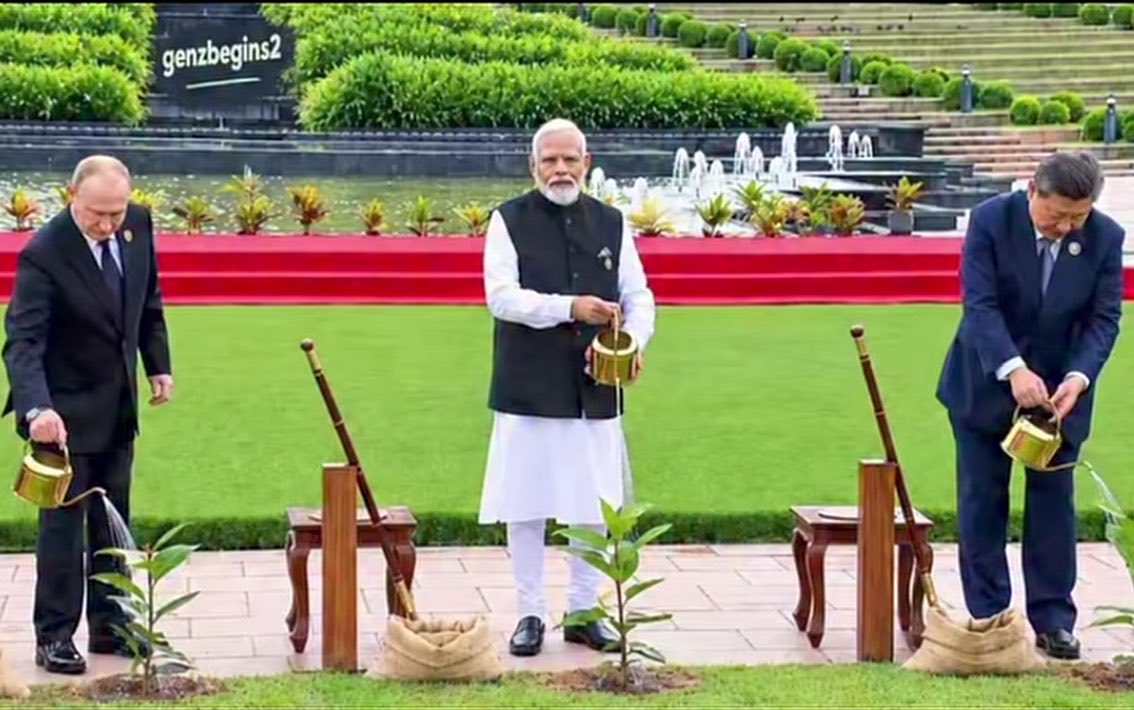 93Yorker's tweet photo. Three powerful world leaders come together to water their ceremonial plants.

Two look toward the plants as one looks straight at the camera. https://t.co/tFDM7TBR7b