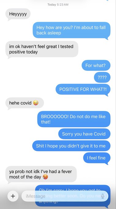 A screenshot of a text conversation where someone casually mentions "im ok haven't feel great I tested positive today," only to later clarify they have COVID, prompting shock from the other person. This relates to the post "My little milker is sick" by revealing the humorous moment of discovering the friend's diagnosis.