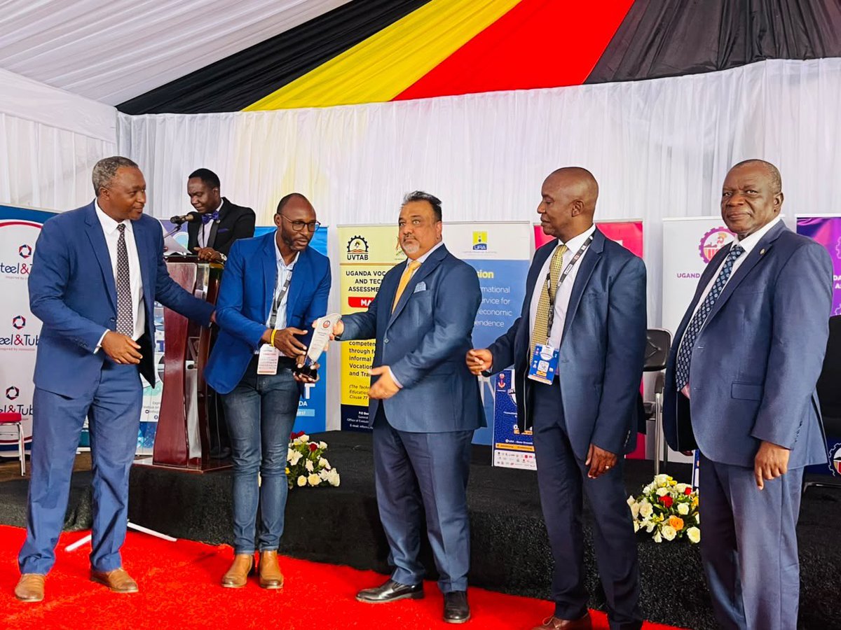 AbubakariSande's tweet photo. Minister Sanjay Tanna Represents President Museveni at 32nd Uganda International Trade Fair.

Minister of Trade, Industry and Cooperatives, Hon. Sanjay Tanna, represented President Yoweri Kaguta Museveni at the 32nd Uganda International Trade Fair at UMA Show Grounds, Lugogo.
During a tour of exhibition stalls led by UMA Executive Director Dr. Ezra Muhumuza Rubanda, Minister Tanna engaged manufacturers and traders on local sourcing of raw materials and the importance of strengthening domestic value chains under the Buy Uganda, Build Uganda (BUBU) agenda.

Delivering the President’s address, Tanna highlighted the need for Uganda to move from exporting raw materials to producing high-value goods through agro-processing, manufacturing, pharmaceuticals, steel, fertilisers and other industries.
President Museveni called for greater investment in innovation, knowledge and value addition, describing the trade fair as a demonstration of Uganda’s ambition to become a production hub rather than a market for imported goods.