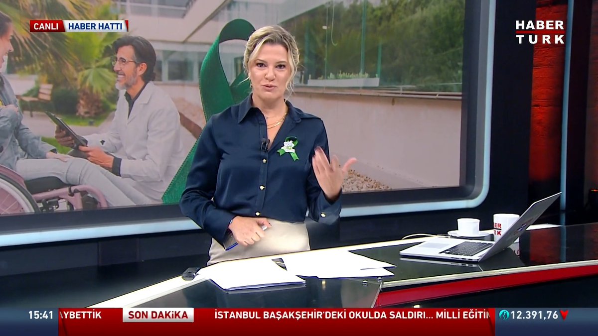 A Haber Türk news anchor presents a live broadcast marked "CANLI HABER HATTI" with the headline "SON DAKİKA" and a scrolling ticker referencing an attack at an Istanbul school, while the background screen displays an image of a person with a disability and a caregiver in relation to Cerebral Palsy Day coverage.