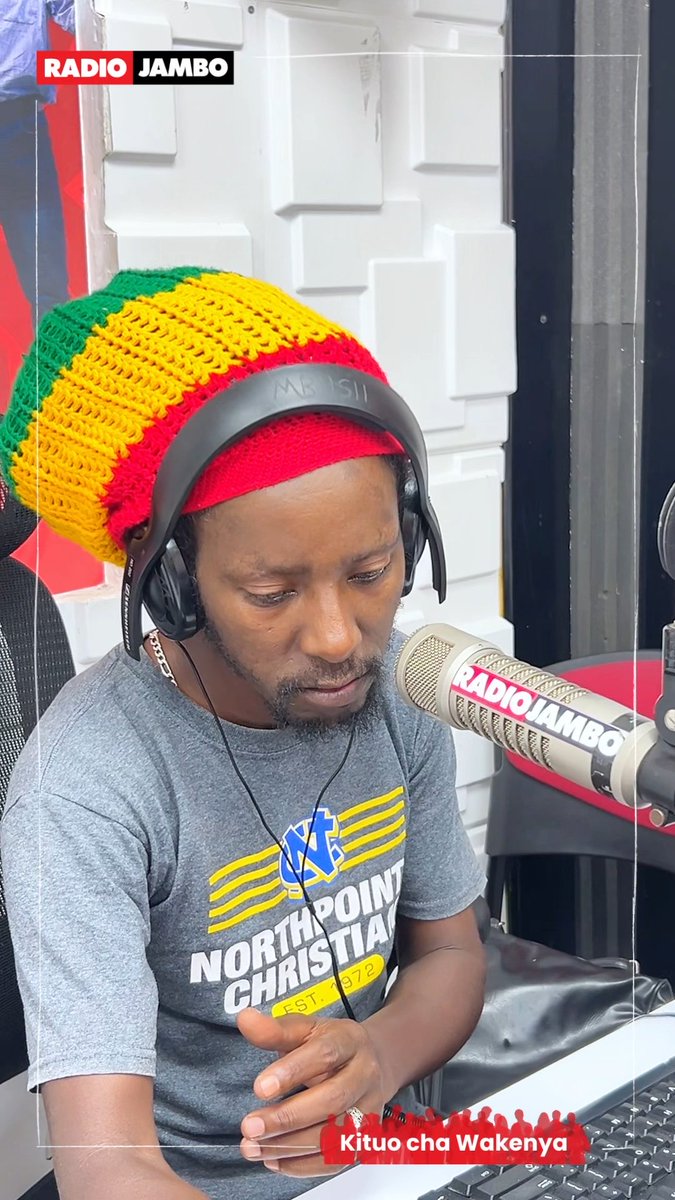 A man wearing a red, yellow, and green crocheted hat and a grey 'Northpoint Christian' t-shirt speaks into a microphone labeled 'RADIO JAMBO', with 'Kituo cha Wakenya' text below.