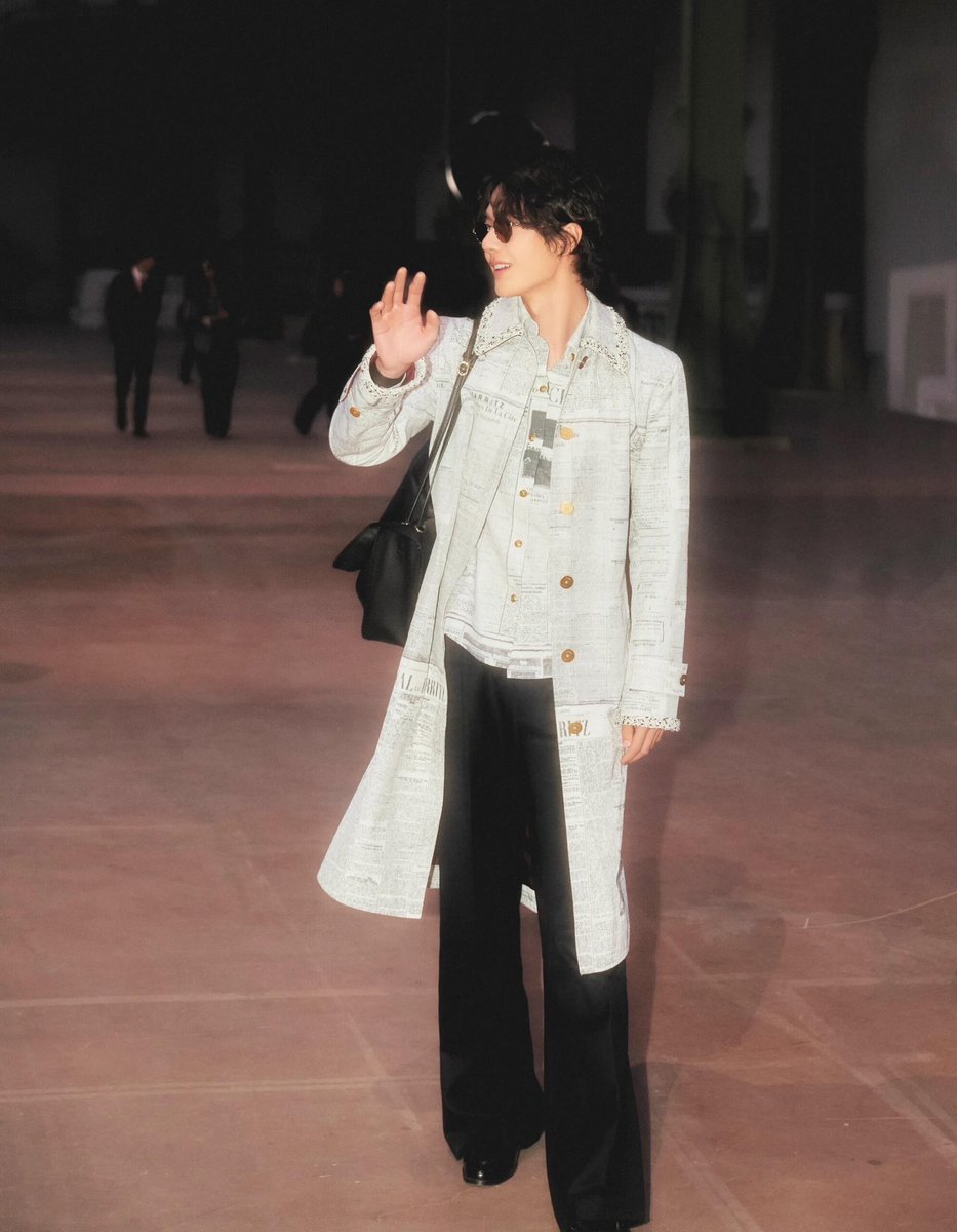latenightxoshow's tweet photo. Wang Yibo is a vision in a newspaper-print coat at the 'Chanel' Spring/Summer 2027 show in Paris. https://t.co/F8V5TCLpJV