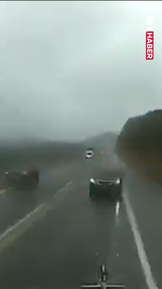 The image shows a foggy highway with vehicles driving in low visibility, including a truck and cars on a multi-lane road, with "TRT HABER" logo visible in the upper right corner. This footage likely depicts the aftermath or approach to the scene of the head-on collision in Mexico, where a car improperly overtook and struck a truck, resulting in 1 fatality and 3 injuries, with the dense fog possibly being a contributing factor to the accident.