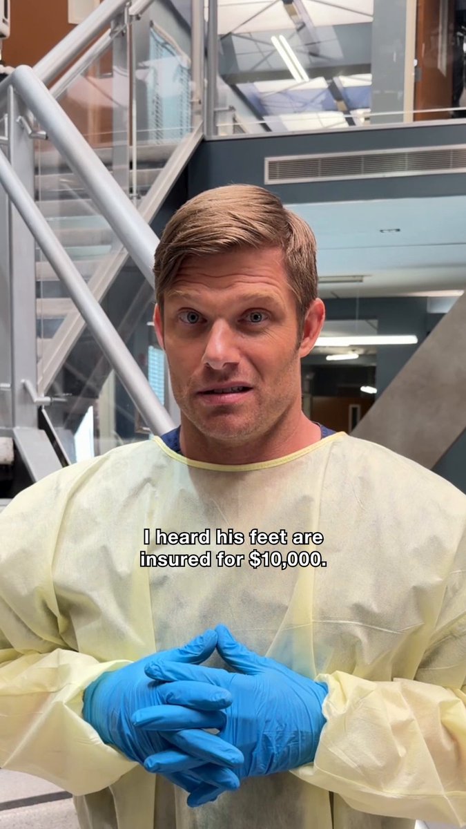 A blonde man in a yellow medical gown and blue gloves stands in a modern building interior with the caption "I heard his feet are insured for $10,000." The post promotes watching DWTS on ABC, tying the image to his dancing career and the humorous mention of insuring his feet.