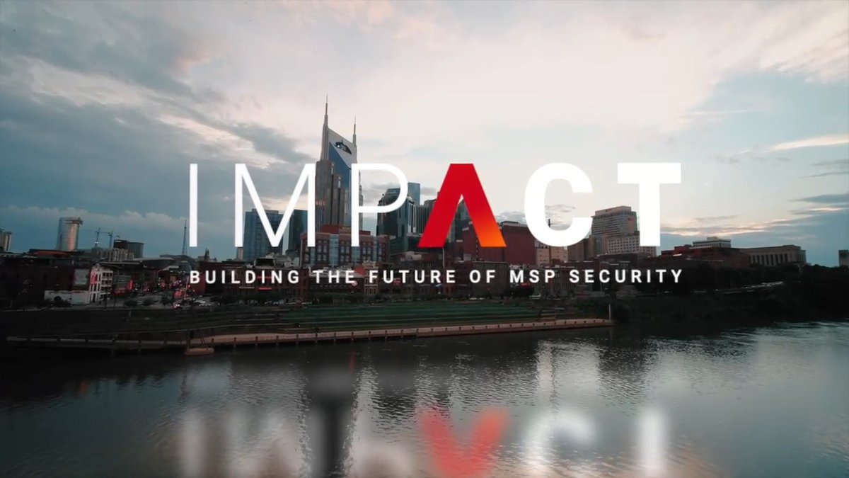 A cityscape at dusk featuring the AT&T building, overlaid with the text 'IMPACT - BUILDING THE FUTURE OF MSP SECURITY' with the A in red.