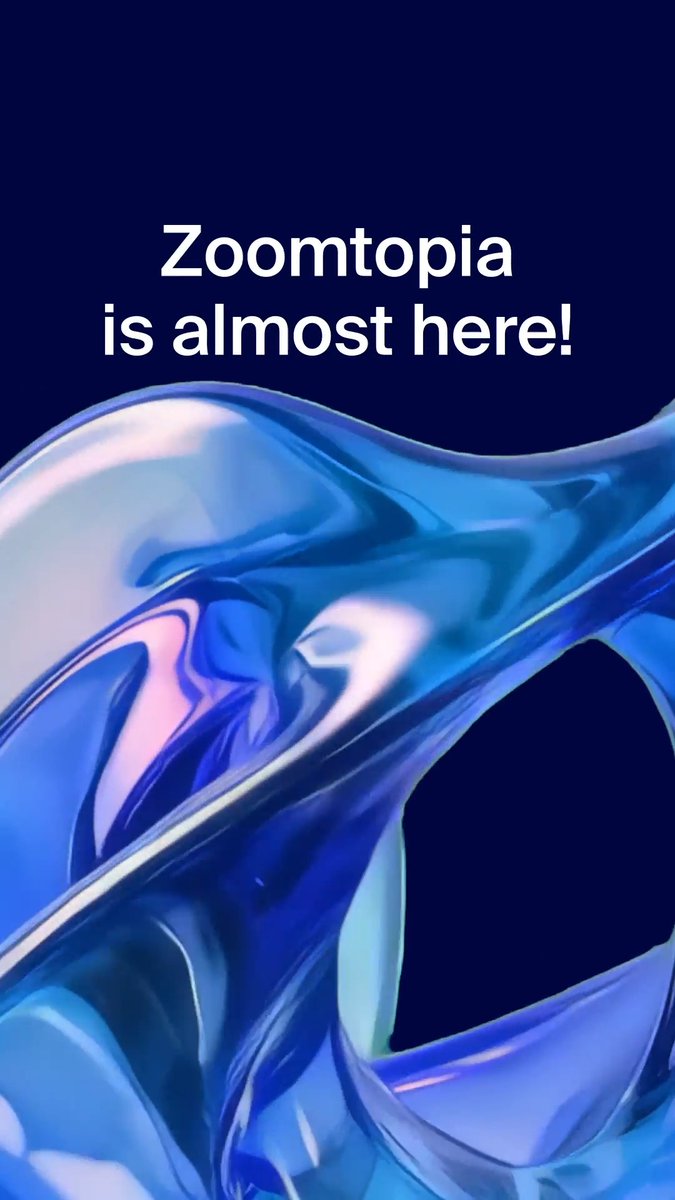 A sleek promotional graphic featuring the bold white text "Zoomtopia is almost here!" against a deep navy background, with flowing iridescent blue and silver fluid-like shapes below. The image visually reinforces the post's message about the upcoming Zoomtopia event, where attendees can discover Zoom's latest AI-first innovations and future of work developments.