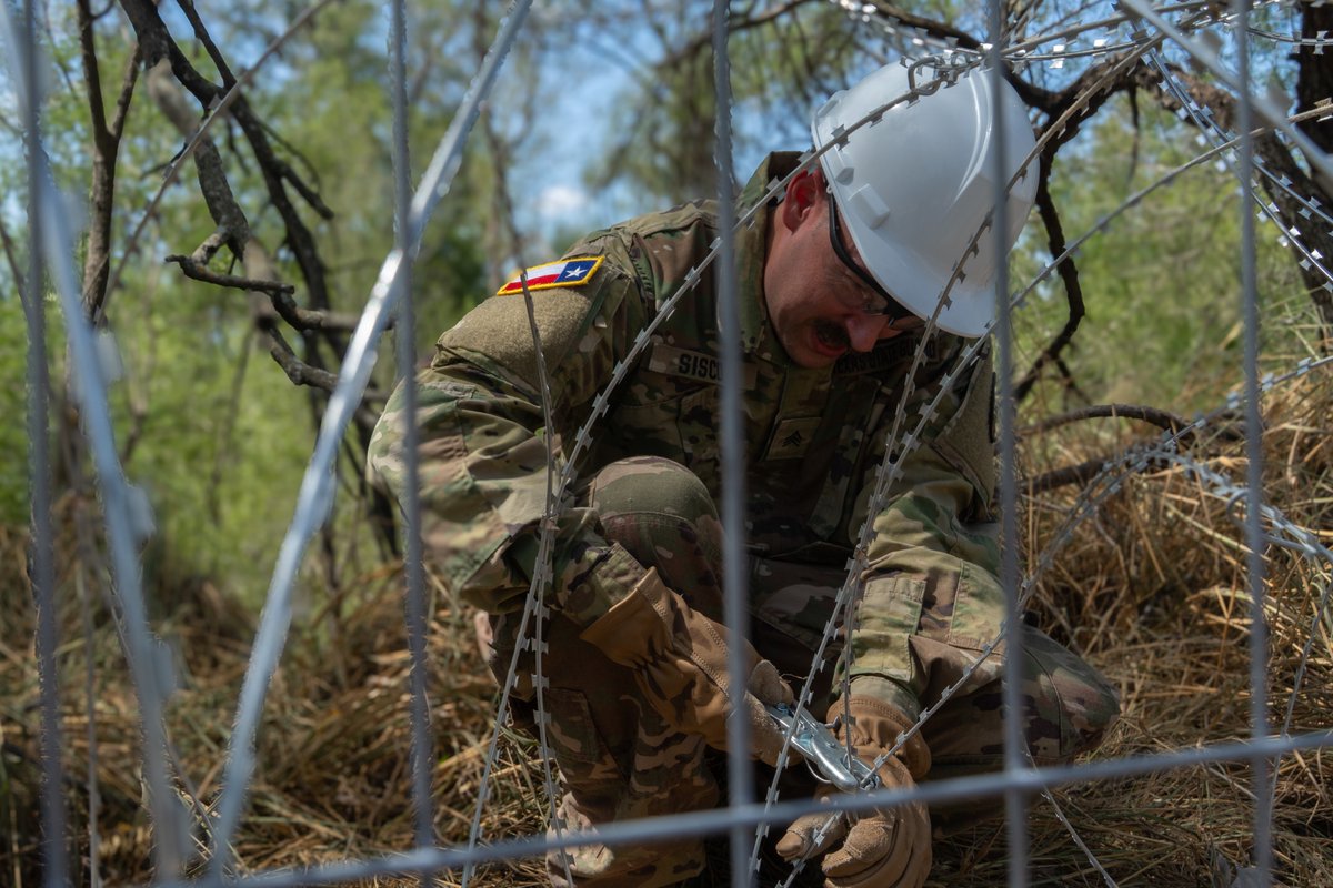 TXMilitary's tweet photo. Strong Barriers - Real Results.

Texas Military Department service members work in coordinated teams installing anti-climb barriers using razor wire and steel panels along the Texas border. Anti-climb barriers provide an effective way to deny illegal crossings and protect Texas communities.

#bordersecurity #Texas