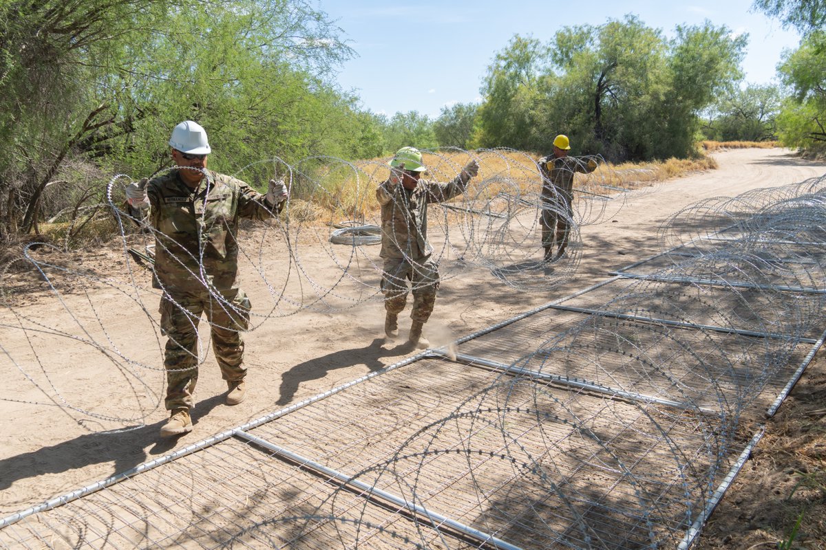 TXMilitary's tweet photo. Strong Barriers - Real Results.

Texas Military Department service members work in coordinated teams installing anti-climb barriers using razor wire and steel panels along the Texas border. Anti-climb barriers provide an effective way to deny illegal crossings and protect Texas communities.

#bordersecurity #Texas