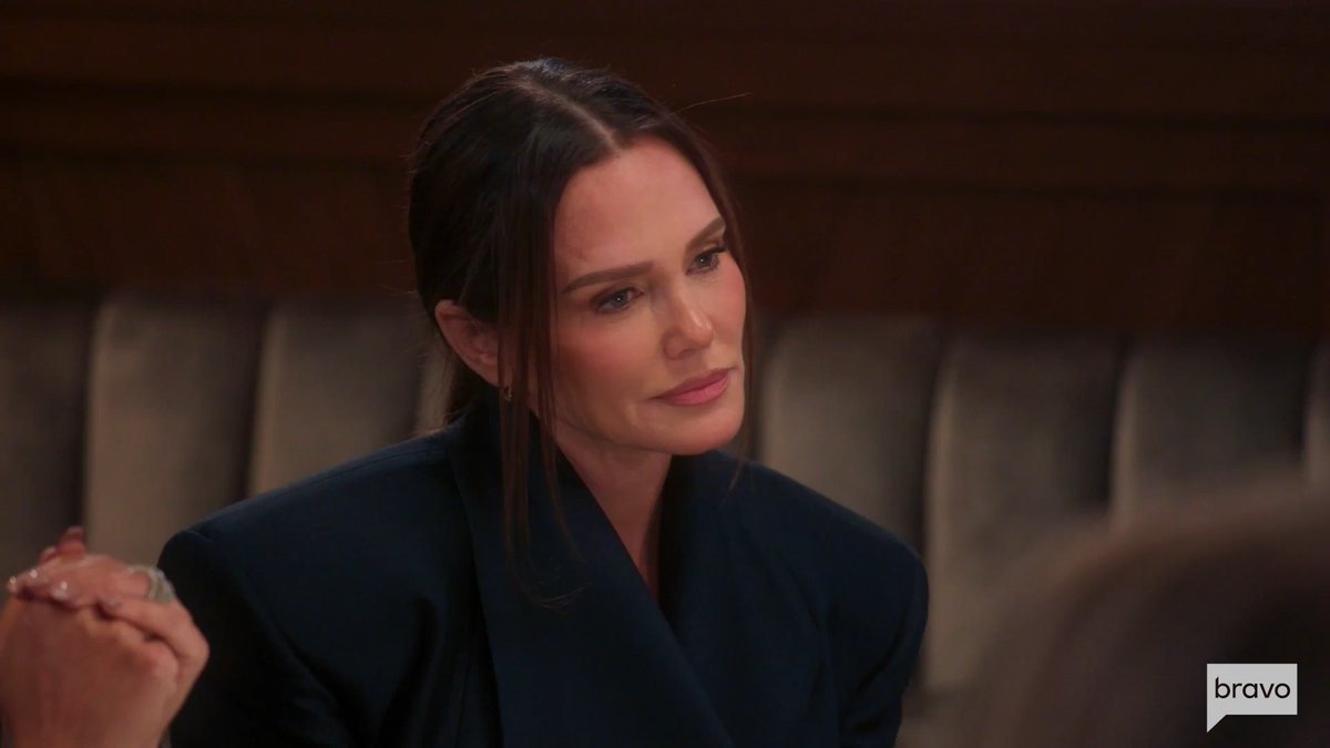 A close-up shot of a woman with dark hair pulled back, wearing a dark blazer, with the 'bravo' network logo in the bottom right corner.
