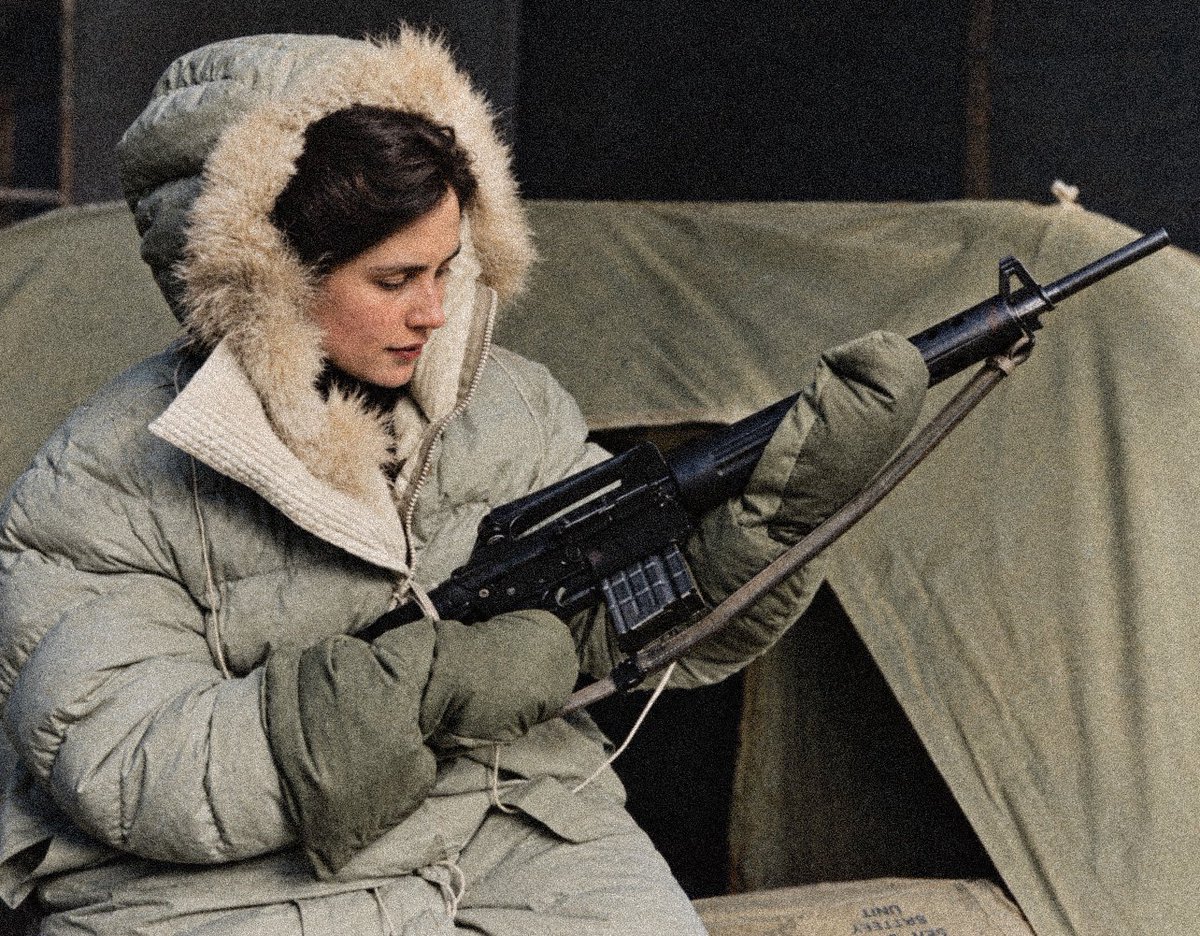 blackstarops's tweet photo. a KLM royal dutch airlines flight attendant wearing arctic survival gear and handling an armalite AR-10 battle rifle included in their emergency kits (1950s) https://t.co/7IYV1aoX50