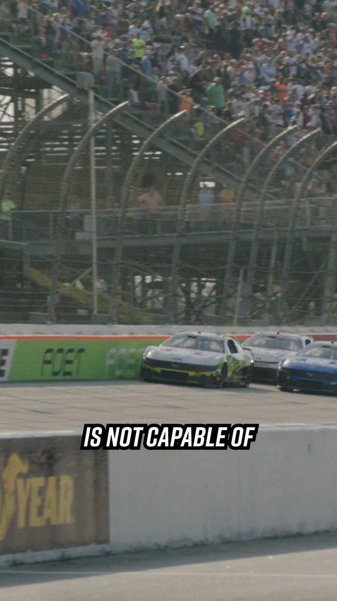 A NASCAR race at Bristol Motor Speedway featuring a black #42 car leading a pack on the track, with grandstands full of fans behind catch fencing. The text "IS NOT CAPABLE OF" is overlaid on the image, which also shows FCET and Goodyear advertising banners.