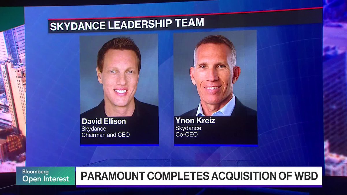 A Bloomberg "Open Interest" segment displays the Skydance leadership team—David Ellison (Chairman and CEO) and Ynon Kreiz (Co-CEO)—under the headline "PARAMOUNT COMPLETES ACQUISITION OF WBD," illustrating the executives behind the newly closed $110 billion merger of Paramount Skydance and Warner Bros. Discovery.
