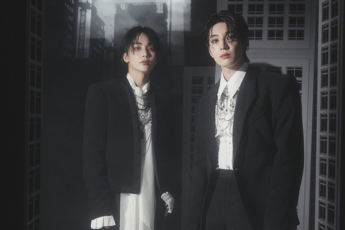 Moonismean's tweet photo. If you haven't listened to the 37-minute JxW “THIS MAN” audiobook, let me actually explain the entire story from beginning to end, because there is so much more happening here than “Wonwoo is a mysterious man who appears in people's dreams.” The story is built around two completely different figures: Wonwoo, the Protector who enters people's dreams to bring them back to reality, and Jeonghan, who creates an entire dream world because he cannot accept the reality of losing someone. And the tragedy is that, from the outside, you don't immediately understand which one is saving people and which one is trapping them.

Wonwoo is the Protector. He moves through the space between dreams and waking life, entering the dreams of sleeping people and seeing the things they carry with them when they fall asleep: their regrets, failed exams, unanswered messages, lost relationships, people they never got to say goodbye to, and all the things that continue hurting even when nobody else can see them. When he finds someone suffering inside their dream, he doesn't erase what happened to them. He simply approaches them, leans down, whispers into their ear, and gives them a peaceful, dreamless sleep.

 When they wake up, they can't properly remember him. All that remains is a vague image of a tall man in a dark coat, a presence they can't quite place. Those fragments slowly turn into a rumor, the rumor becomes an urban legend, and the figure comes to be known as “THIS MAN.”

Then there is Jeonghan, whose story exists somewhere completely outside the normal flow of reality. His world is permanently stuck at 8:47 AM. The same morning keeps repeating because Jeonghan created this world for one reason: someone called “A” has disappeared from his life, and he cannot accept that A is gone.

So instead of returning to reality and grieving, Jeonghan builds a place where A can still exist. Breakfast is always prepared. The surroundings remain familiar. Everything stays exactly as he wants it to be. But there is a problem with the world he created: a dream can recreate the appearance of something you remember, but it cannot truly bring back someone who is gone. And Jeonghan's memories are beginning to disappear.

At first, it's small details. Then A's voice becomes harder to remember. Eventually, Jeonghan can no longer remember A's face. That is what frightens him most, because as long as he can remember A, he can continue pretending that A is still there. So he covers A's head with a white cloth and cuts two holes for the eyes. He no longer has to look at a face he can't remember. The figure underneath the cloth can remain A simply because Jeonghan chooses to believe it is A.

But eventually, A runs away.

And once A disappears, Jeonghan's dream world begins to deteriorate. The sanctuary he created needs something to keep it going, so Jeonghan starts entering other people's dreams. He approaches sleeping people and offers them the same escape he created for himself: “Come with me to a place where wishes come true.”

People follow him because the offer is almost impossible to refuse. In their dreams, they can have the things they don't have in reality. They don't have to deal with regret, loneliness, failure, or loss. They can simply stay somewhere beautiful. But the more people Jeonghan brings into his world, the more their dreams become part of the world he has created.

And while all of this is happening inside the dream, something terrifying is happening outside.

People across the city begin falling asleep. They collapse on buses, in offices, on the streets, and in other public places, but they aren't screaming or fighting it. They are sleeping peacefully, often with happy expressions on their faces. Even television broadcasts begin to disappear because the people working there have fallen asleep. Little by little, the waking city becomes empty because people are choosing the dream over reality.