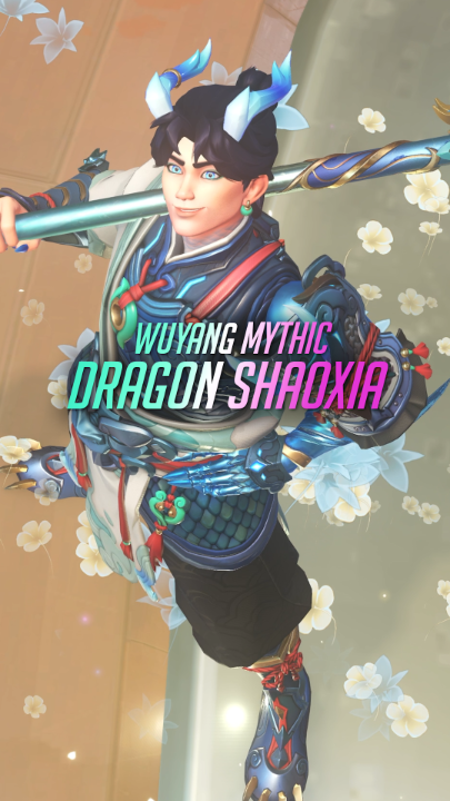 A promotional image showcases the new Overwatch Mythic skin "Wuyang Mythic Dragon Shaoxia," featuring the character Wuyang in ornate blue and green dragon-themed armor with horn-like headpiece accents, holding a staff amid floating white blossoms. The vibrant character render aligns with the trailer announcement, highlighting the mythological Chinese-inspired design elements of this premium cosmetic.