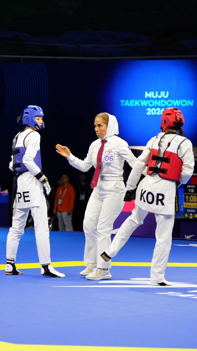 A photo from the Muju Taekwondowon 2026 competition showing a referee in a white headscarf separating two female taekwondo athletes wearing protective gear, one representing TPE (Chinese Taipei, number 06) and the other KOR (Korea).