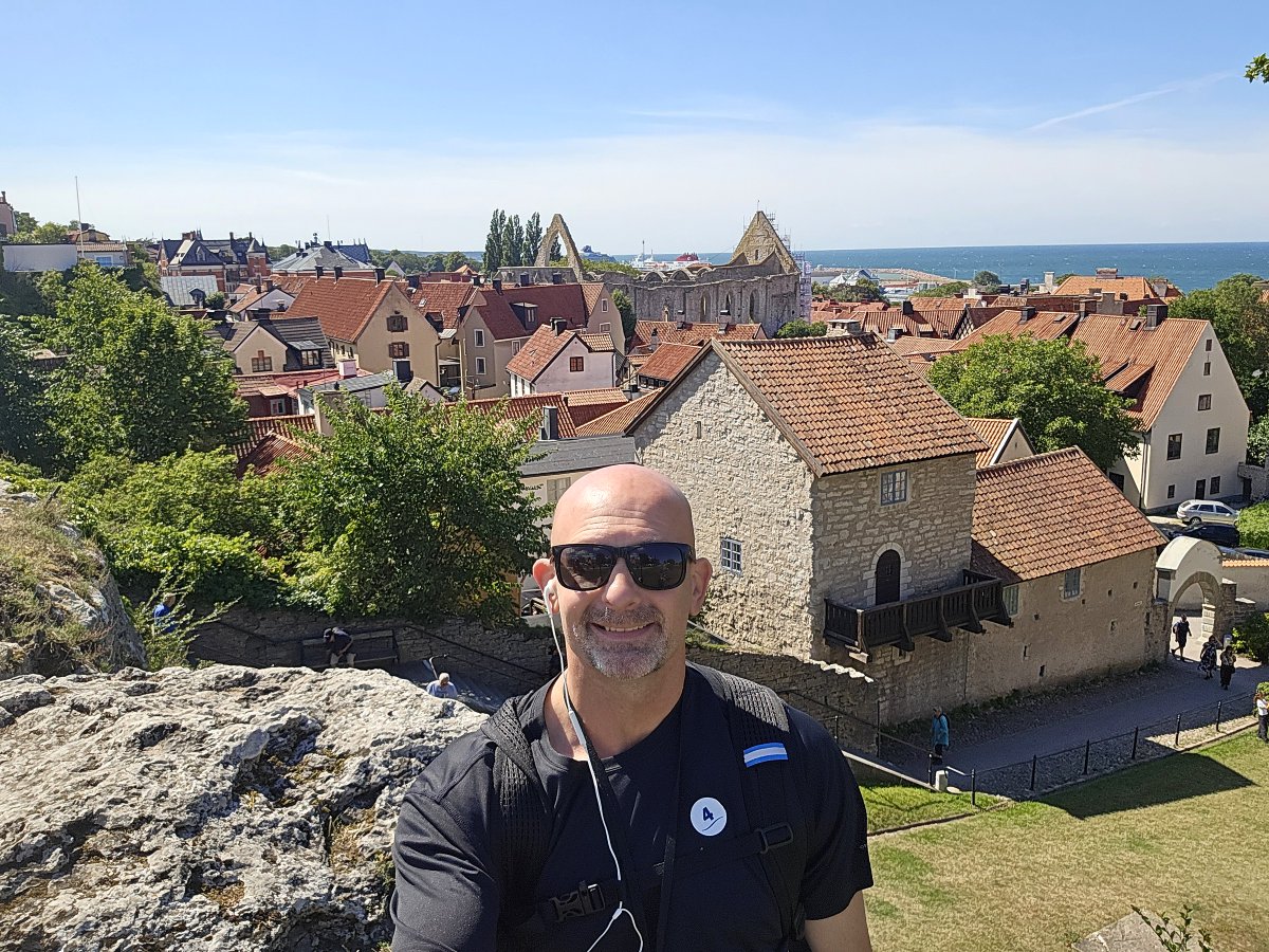Andy_FSTA2025's tweet photo. A beautiful view of Old Town Visby in the background with the sun shining on my bald head #BaldIsBeautiful #Visby https://t.co/oMJe7jel0z