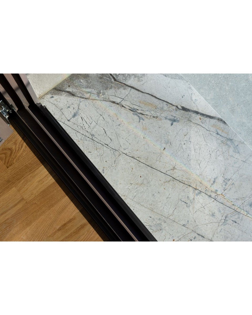 johnhernandezkg's tweet photo. Smíchov City ~ Gray sills and reveals made of honed Turkish Silver Roots marble, with distinctive dark veining, complement the rough plaster in color and texture, creating a subtle yet visually striking impression. https://t.co/wAlp02mGdD