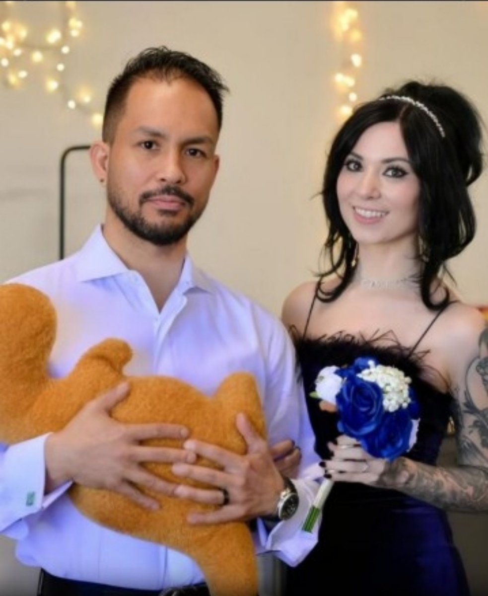 JeremyHamFlabby's tweet photo. Why was Mr Mel Mac holding this in their wedding photo? Is it a surrogate stuffed child replacement, due to her barren empty womb? Or are they just immature and playing house together. Larping as they larp the larp they do? Please do tell us oh wise manly man #JohnnyJunkers https://t.co/PYo858K4f2