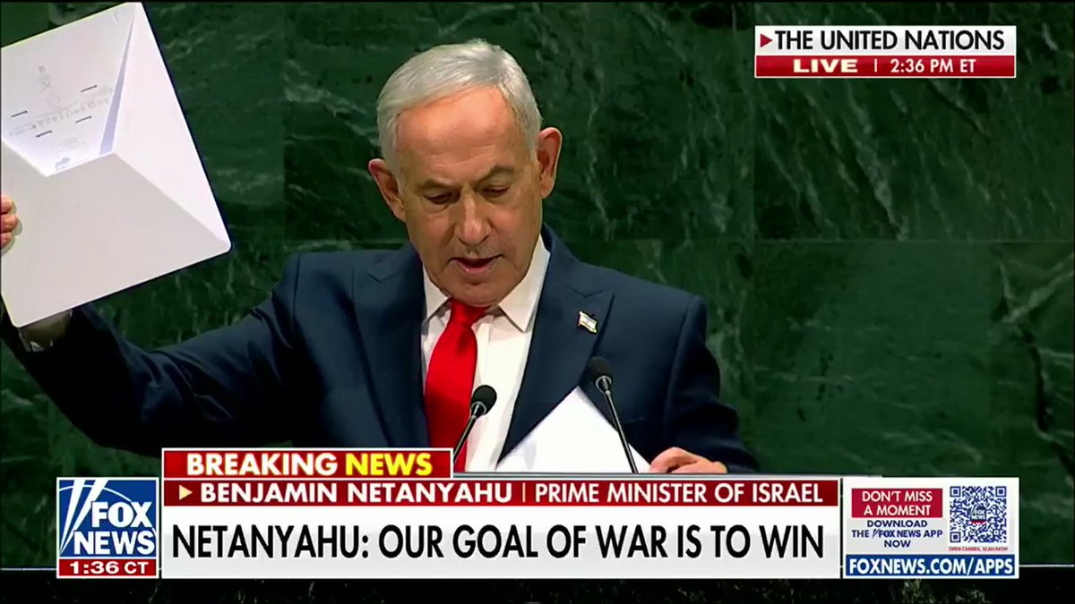 Israeli Prime Minister Benjamin Netanyahu holds up a Starlink device while addressing the United Nations, as displayed in a Fox News broadcast at 2:36 PM ET, with the chyron reading "NETANYAHU: OUR GOAL OF WAR IS TO WIN." The image visually supports his statement about presenting the Starlink communications device as a symbol of freedom and truth during his UN speech targeting Iran.