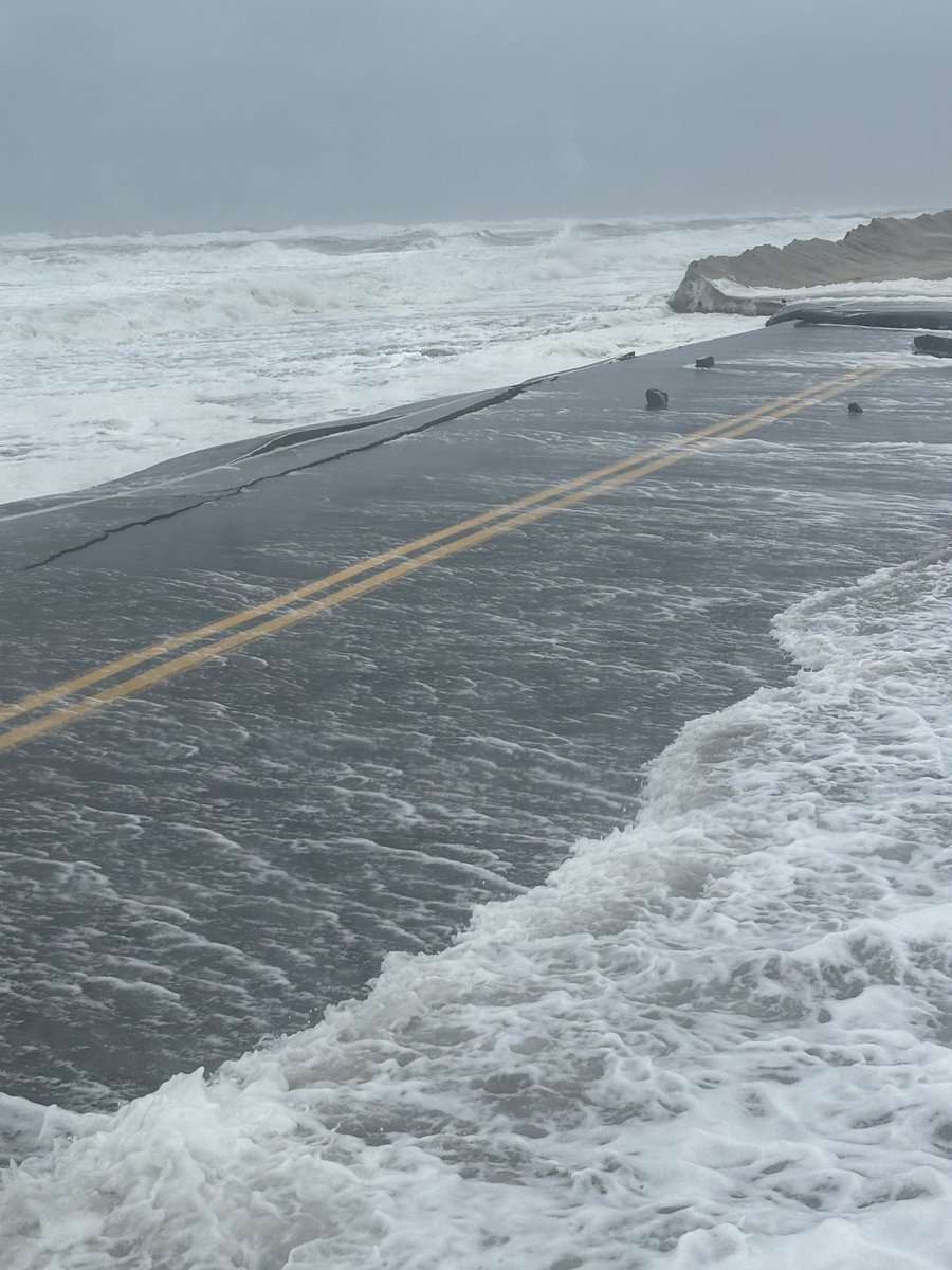 NCDOT's tweet photo. NC 12, in the OBX, is closed from the Basnight Bridge to Rodanthe, due to weather. The storm pushed ocean water during high tide through the protective sand dunes, damaging pavement near Pea Island. NCDOT crews are currently accessing damage. There is no estimate on reopening. https://t.co/DucxynKR1Q