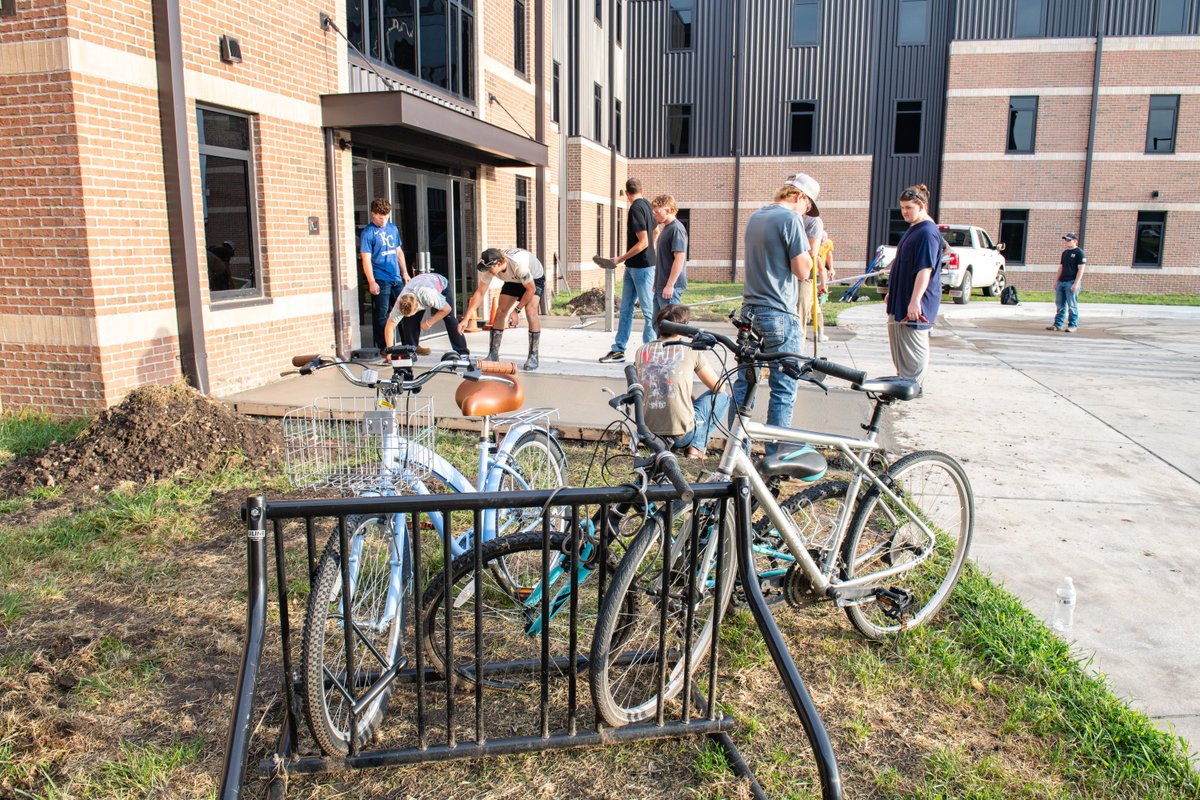 sfccmo's tweet photo. SFCC Construction Management students, pictured with instructor Logan Carter, poured concrete for new bike racks outside the Campus Housing Complex. Thank you to everyone who helped make this hands-on project possible! 👷🚲 https://t.co/bQQQ35ji5C