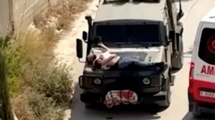 WarFrontIntel's tweet photo. Are you sure? They strapped a Palestinian human shield to the front of their truck. https://t.co/4lSurq1km5