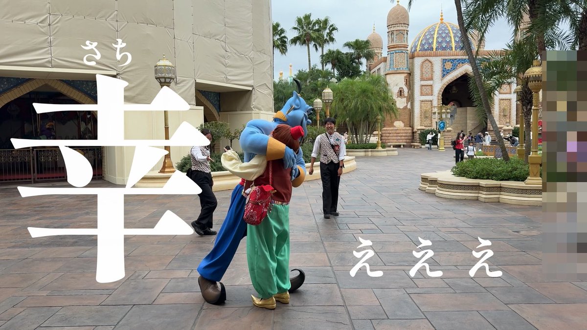 Aladdin (Alam) embraces the Genie mascot at Tokyo DisneySea's Arabian Coast, with a cast member in a vest smiling nearby. The overlaid text "さち幸せ" (sachi shiawase, meaning "happiness") and "えええ" captures the joyful excitement of this Halloween costume outing.