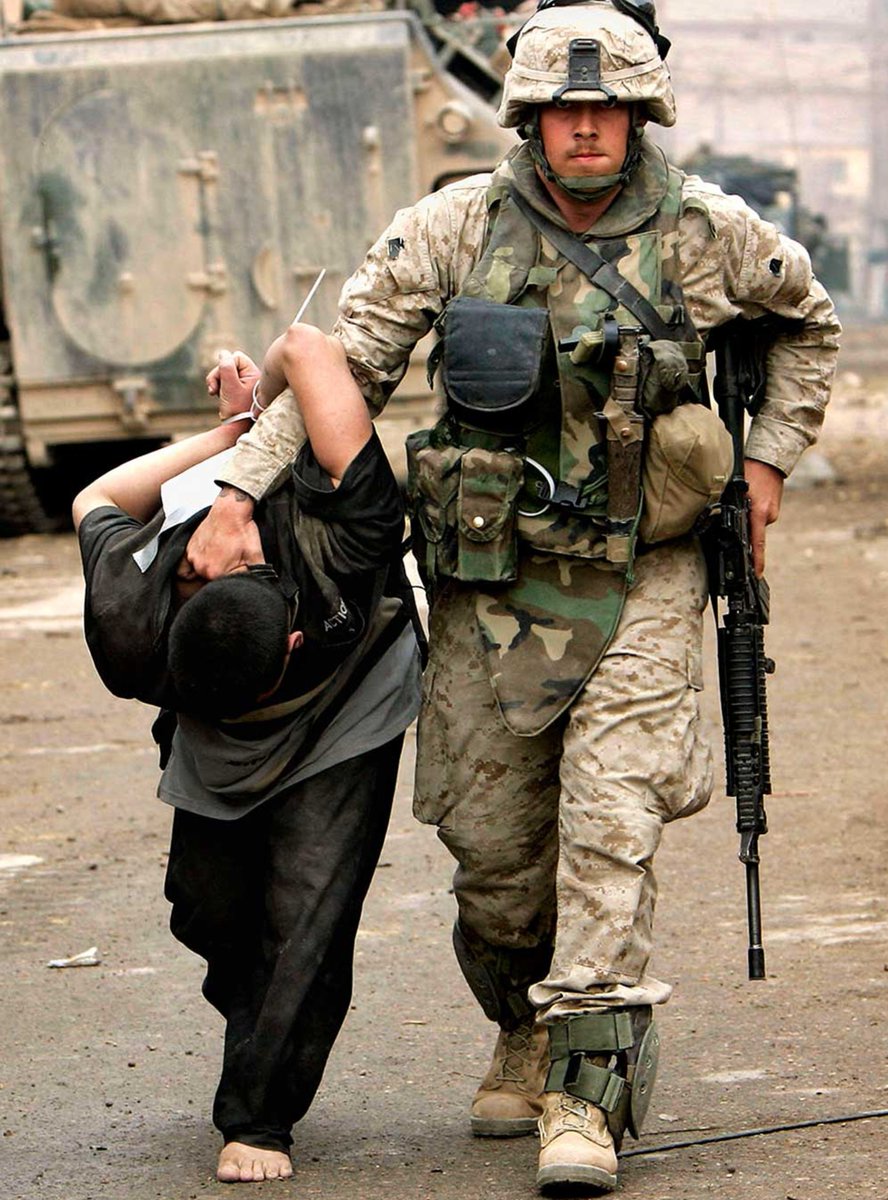 specialopsmag's tweet photo. The iconic photograph of a US Marine escorting a detained individual in the city of Fallujah, Iraq, during the heavy fighting of November 2004. https://t.co/K9fZ9g47D6