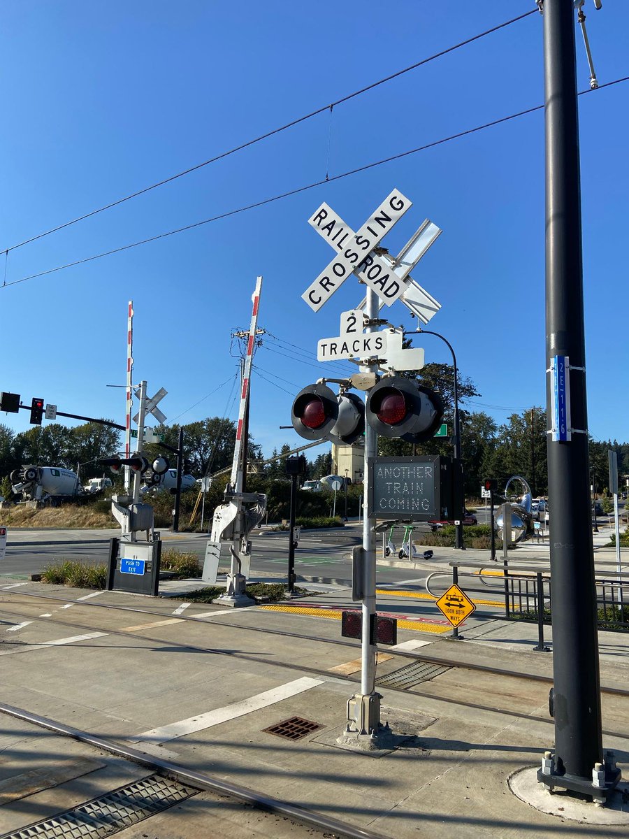 SoundTransit's tweet photo. What is this thing? 👀 

This is an automatic pedestrian gate! Many people are familiar with its predecessor—the automatic quad gate which is a traffic control device used to warn people in vehicles that a train is approaching and prevent them from entering a train's right of way.  

When a train approaches, lights begin to flash, bells ring, and the automatic pedestrian gate arm descends across sidewalks or crosswalks where people walk, bike, or roll to warn people of an oncoming train.  

These automatic pedestrian gates are near BelRed Station, which opened in 2024. Sound Transit will install automatic pedestrian gates at Royal Brougham with construction starting as soon as late 2027.   

#BehindYourRide