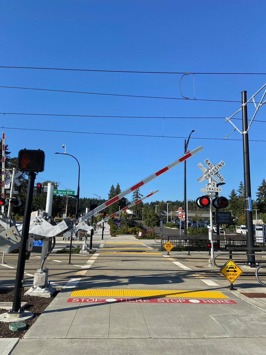 SoundTransit's tweet photo. What is this thing? 👀 

This is an automatic pedestrian gate! Many people are familiar with its predecessor—the automatic quad gate which is a traffic control device used to warn people in vehicles that a train is approaching and prevent them from entering a train's right of way.  

When a train approaches, lights begin to flash, bells ring, and the automatic pedestrian gate arm descends across sidewalks or crosswalks where people walk, bike, or roll to warn people of an oncoming train.  

These automatic pedestrian gates are near BelRed Station, which opened in 2024. Sound Transit will install automatic pedestrian gates at Royal Brougham with construction starting as soon as late 2027.   

#BehindYourRide