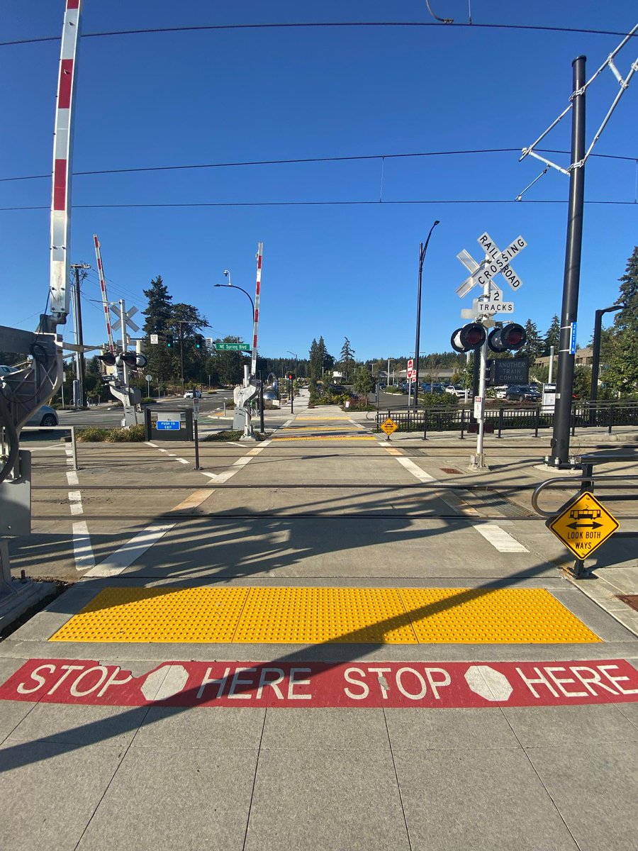 SoundTransit's tweet photo. What is this thing? 👀 

This is an automatic pedestrian gate! Many people are familiar with its predecessor—the automatic quad gate which is a traffic control device used to warn people in vehicles that a train is approaching and prevent them from entering a train's right of way.  

When a train approaches, lights begin to flash, bells ring, and the automatic pedestrian gate arm descends across sidewalks or crosswalks where people walk, bike, or roll to warn people of an oncoming train.  

These automatic pedestrian gates are near BelRed Station, which opened in 2024. Sound Transit will install automatic pedestrian gates at Royal Brougham with construction starting as soon as late 2027.   

#BehindYourRide