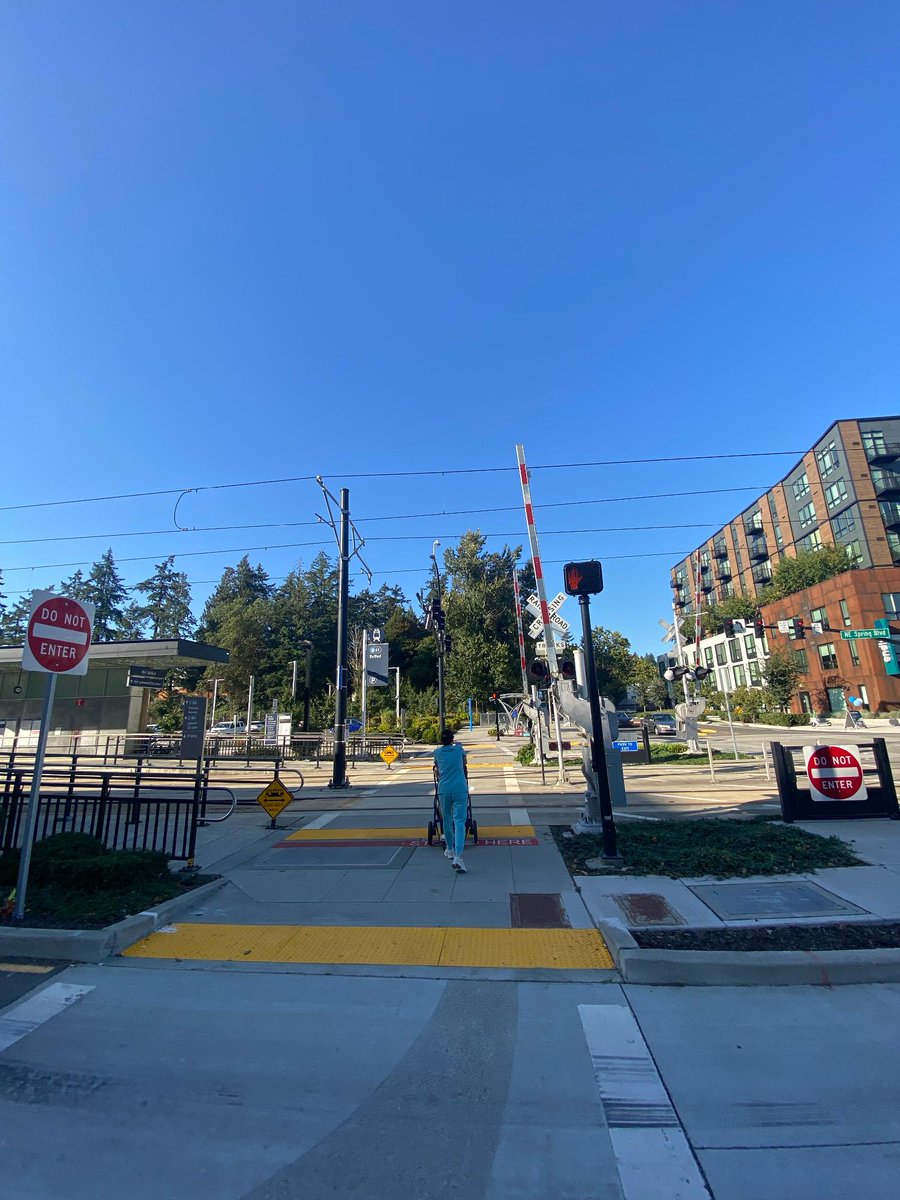 SoundTransit's tweet photo. What is this thing? 👀 

This is an automatic pedestrian gate! Many people are familiar with its predecessor—the automatic quad gate which is a traffic control device used to warn people in vehicles that a train is approaching and prevent them from entering a train's right of way.  

When a train approaches, lights begin to flash, bells ring, and the automatic pedestrian gate arm descends across sidewalks or crosswalks where people walk, bike, or roll to warn people of an oncoming train.  

These automatic pedestrian gates are near BelRed Station, which opened in 2024. Sound Transit will install automatic pedestrian gates at Royal Brougham with construction starting as soon as late 2027.   

#BehindYourRide