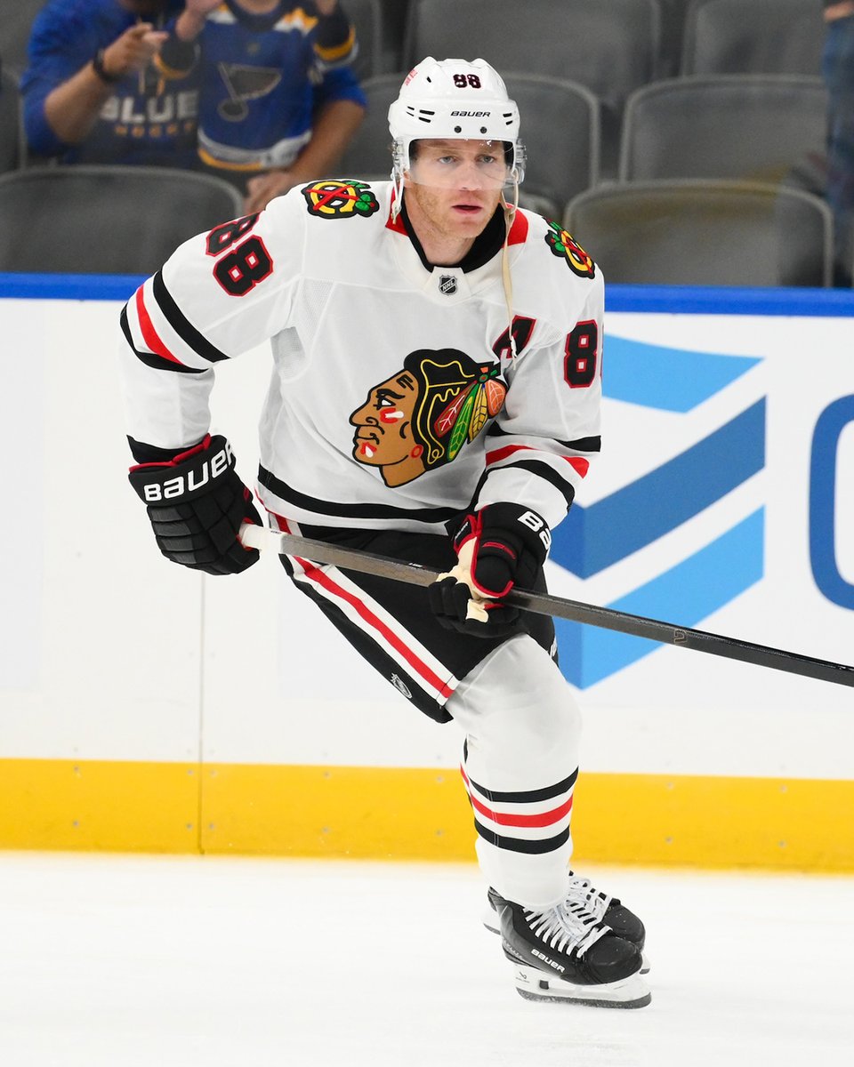 Patrick Kane warming up on ice in a Blackhawks uniform.