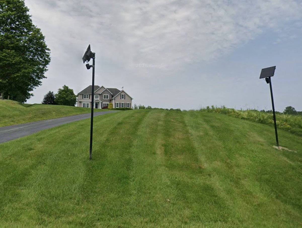 HIBFlocked's tweet photo. Two Flock cameras on someone's lawn, near the end of a dead-end street. https://t.co/hKx4ovNW3L