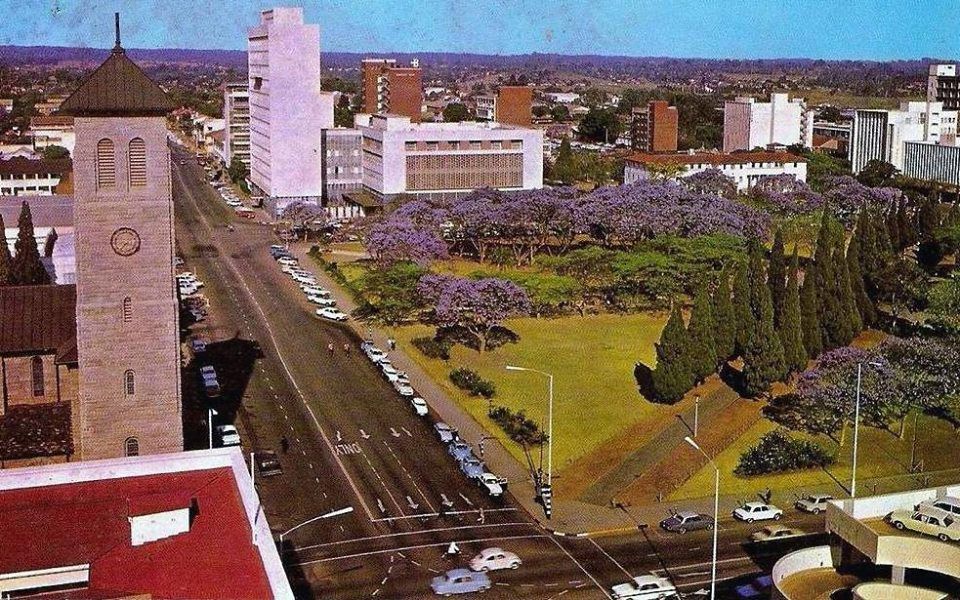 RhodesianAction's tweet photo. Salisbury in the 1960s, jacarandas in full bloom along the main road. The capital held its jacaranda festival every October, and for a few weeks the whole city turned purple. https://t.co/JriVtpSDrr