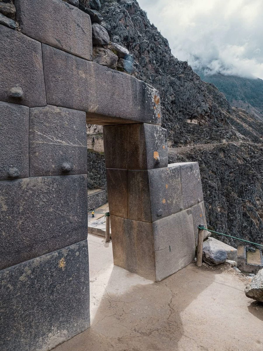 UnearthedHQ's tweet photo. THE SECRET BEHIND THIS 500-YEAR-OLD INCA FORTRESS

High in the remote Peruvian Andes stands a doorway that looks almost impossible to build. At Ollantaytambo, an ancient Inca fortress and ceremonial center, enormous granite blocks were shaped, moved, and fitted together with remarkable precision more than 500 years ago.

The site is believed to have been developed during the reign of Inca Emperor Pachacuti in the mid-15th century. What makes these stone structures so fascinating is the incredible accuracy of the workmanship. Massive blocks were carefully cut and joined together without modern machinery, creating walls and entrances with remarkably tight-fitting joints.

Then there is the doorway itself. Its dark, trapezoidal opening leads into a sunlit space beyond, while the weathered stones around it carry the marks of centuries of wind, rain, and time. Orange lichen now grows across parts of the ancient surface, making the doorway look even older and more mysterious.

Standing before this entrance today, it is easy to wonder what the people who built it saw when they walked through it centuries ago—and what secrets may still be hidden among these enormous stones.

Ollantaytambo is more than a ruin. It is a surviving piece of a civilization whose engineering skills continue to leave us with questions.