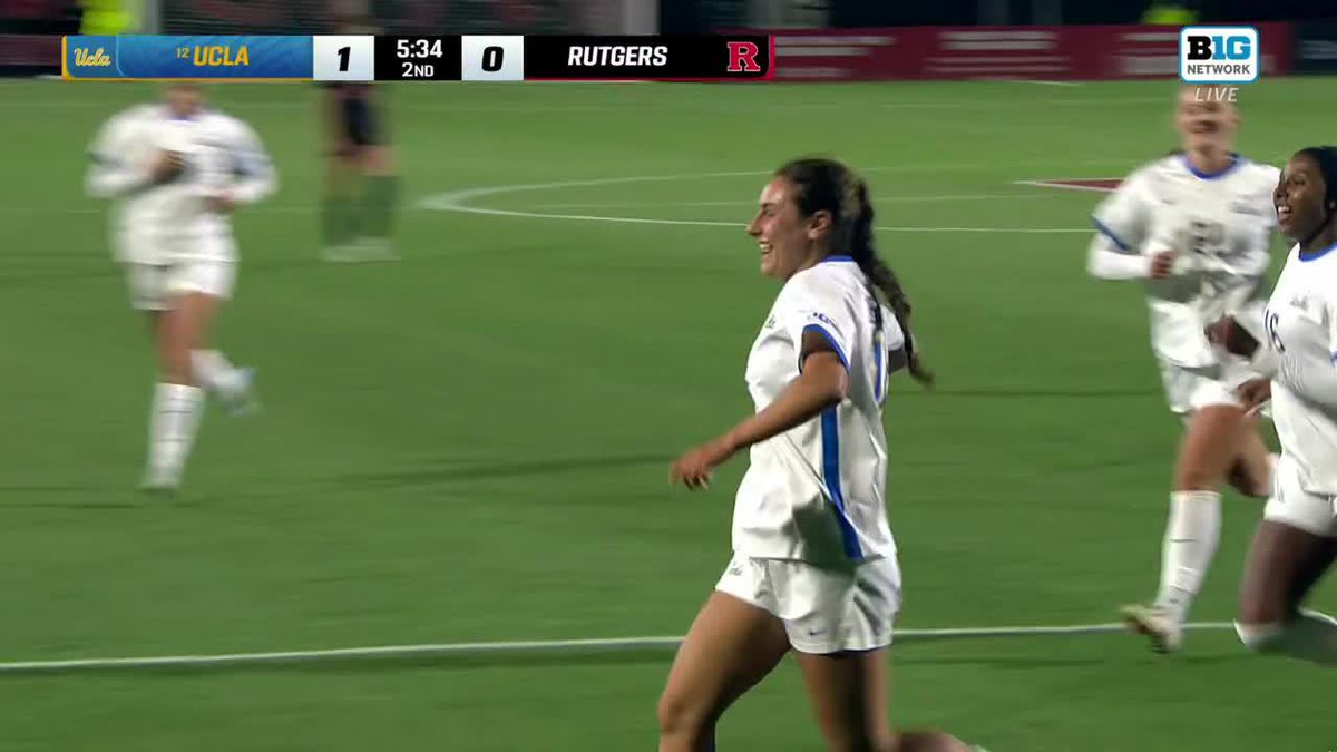 UCLA players celebrate a goal by #10 Cate Sarinopoulous as the scoreboard shows the #12 Bruins leading Rutgers 1-0 with 5:34 left in the 2nd half.