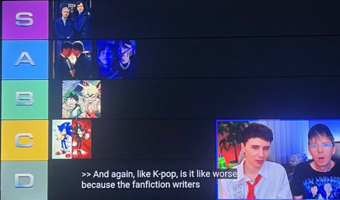 A tier list image ranking K-pop groups (S, A, B, C, D) with various band photos, alongside a video clip of two male commentators discussing K-pop fanfiction writers.