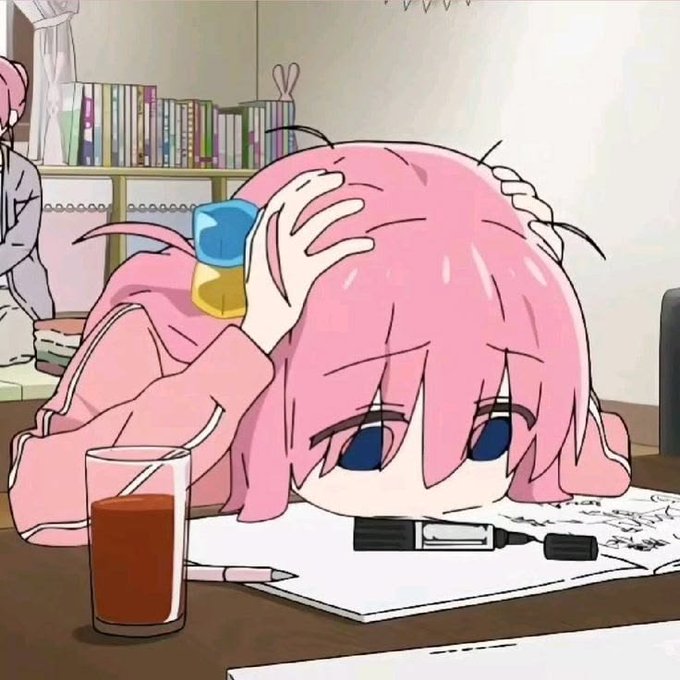 An anime-style illustration of a pink-haired character resting their head on a desk, with a juice box on their head and a drink nearby.