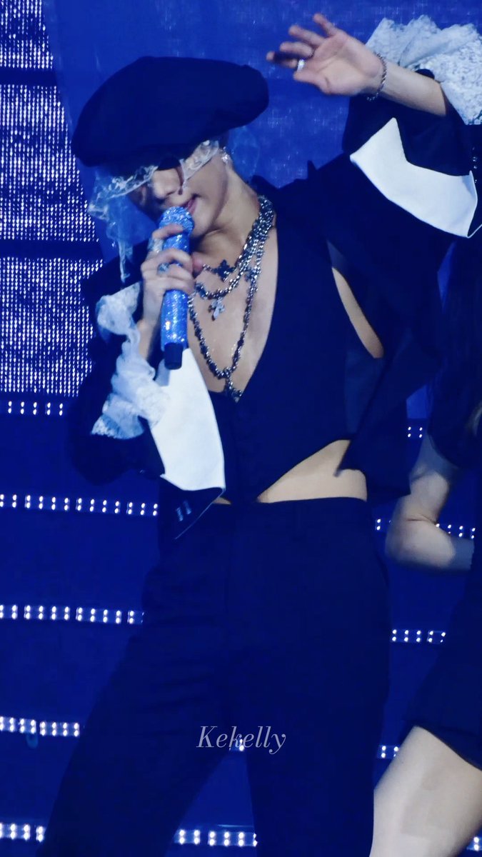 A performer in a black beret, lace gloves, and deep-V outfit sings into a sparkly blue microphone on a stage lit with cool blue lights, captured during what appears to be the "MOVE" tour stop on 9/26. A watermark reading "Kekelly" is visible at the bottom, indicating the fan who took the photo.